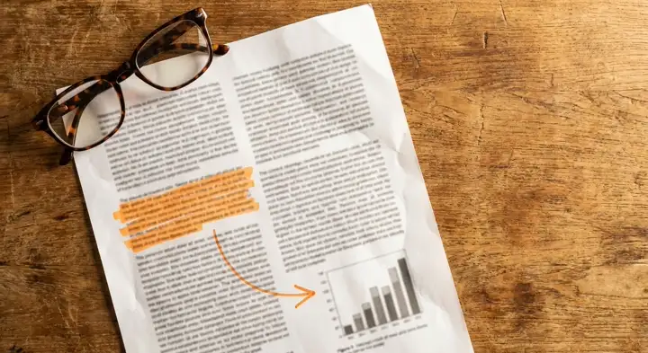 A printed clinical study page with one paragraph highlighted in orange